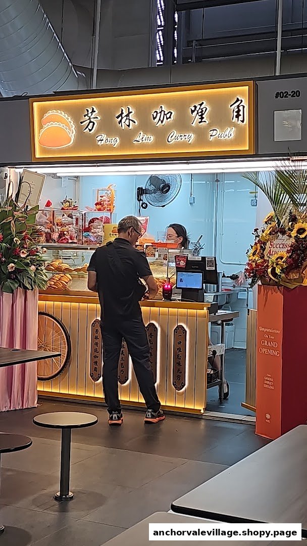 A customer stands at the counter of Hong Lim Curry Puff, with the illuminated shop sign visible.