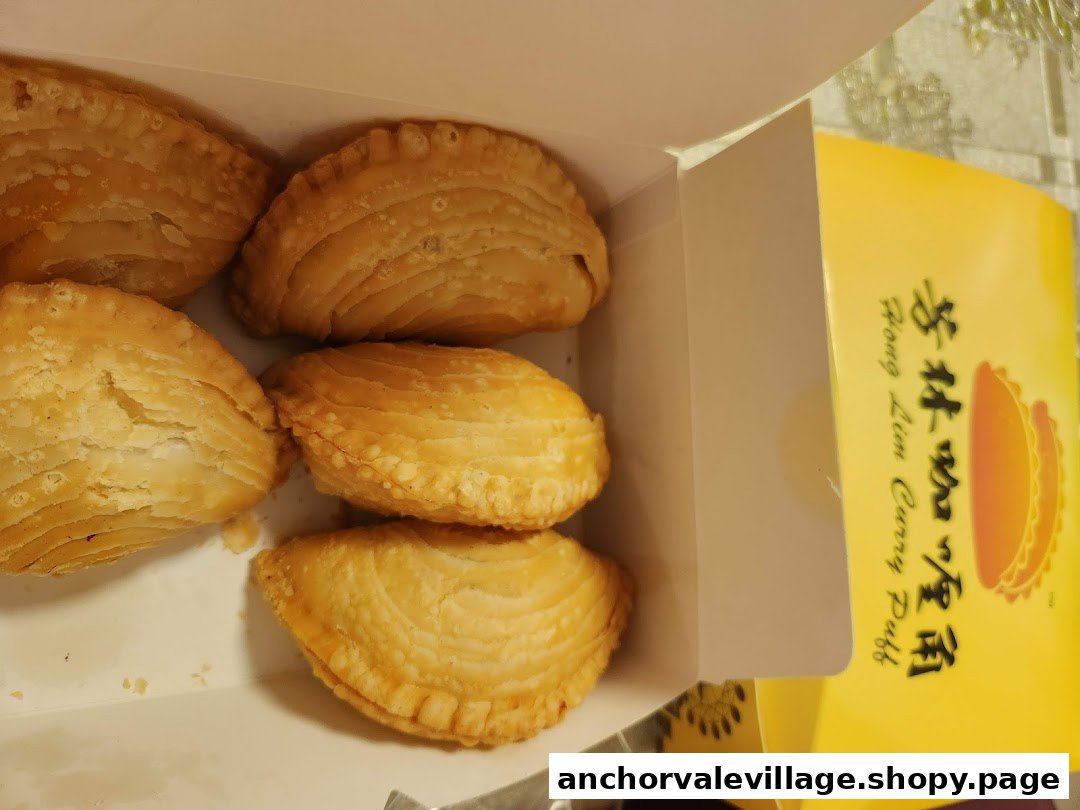 A box of golden-brown, flaky curry puffs from Hong Lim Curry Puff.