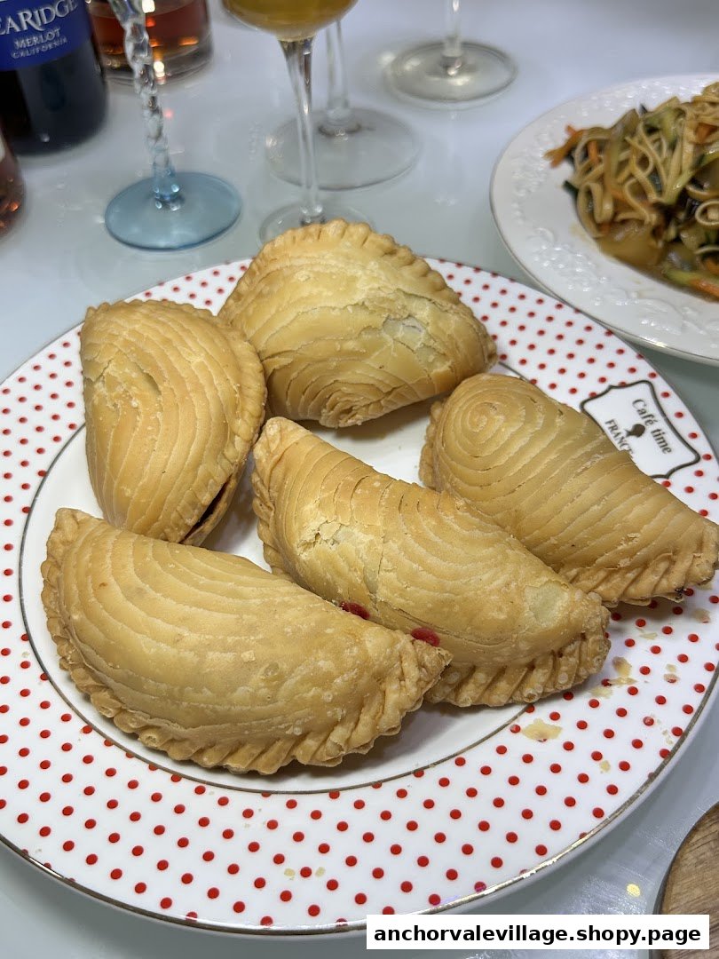 A plate of golden-brown curry puffs with flaky pastry, ready to be enjoyed.