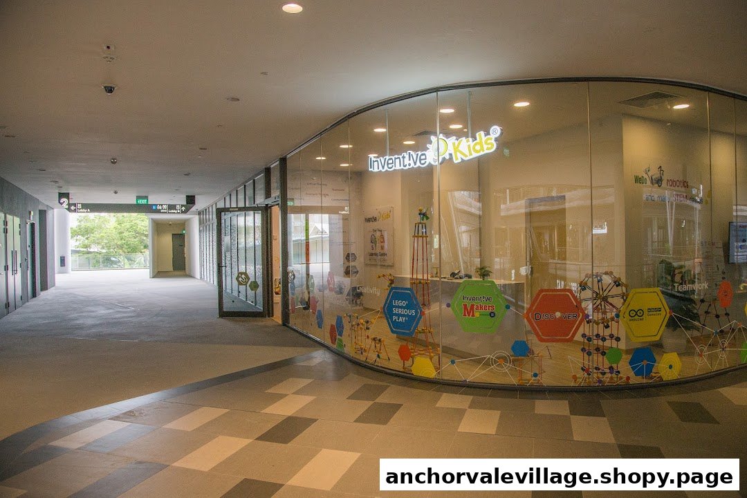 The curved glass facade of Inventive Kids Play-based STEM Learning Centre, showcasing its vibrant interior.