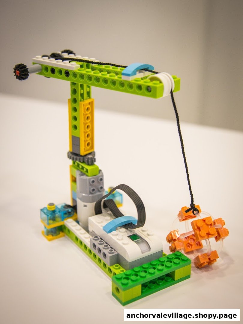 A colorful, intricate LEGO-like model of a crane with a suspended object, showcasing STEM learning.
