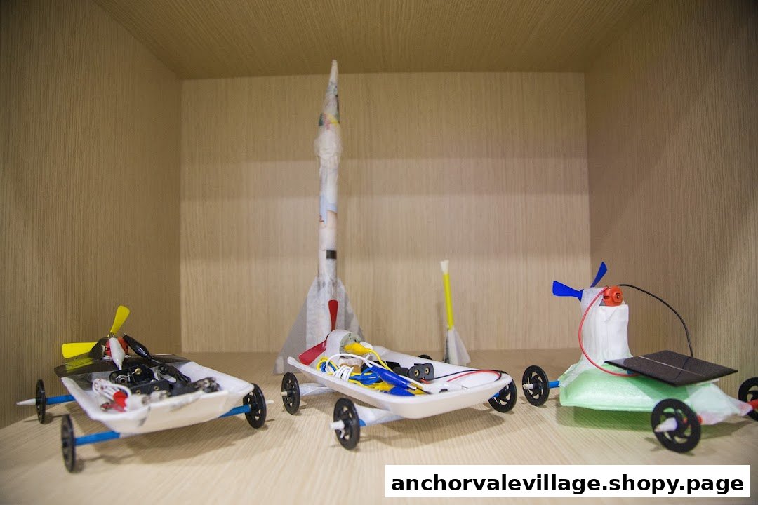 Handmade STEM projects including propeller cars, a solar car, and rockets displayed on a shelf.