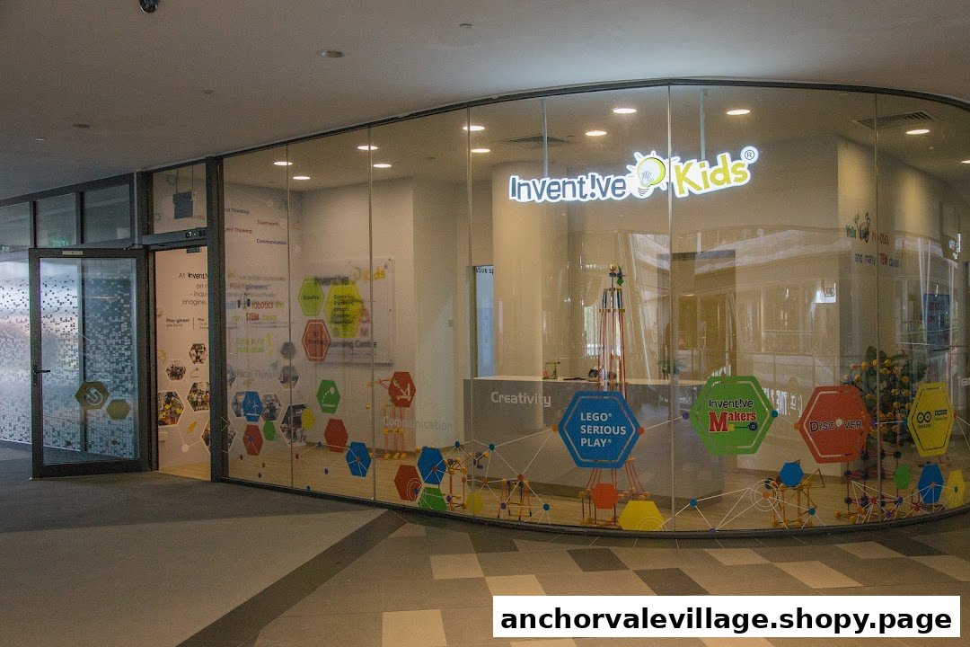 The storefront of Inventive Kids Play-based STEM Learning Centre, featuring a glass facade with colorful educational graphics.
