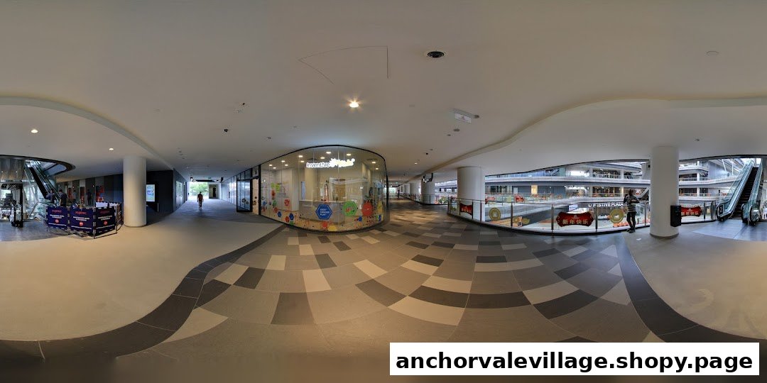 A curved glass storefront of Inventive Kids Play-based STEM Learning Centre in a modern shopping mall corridor.