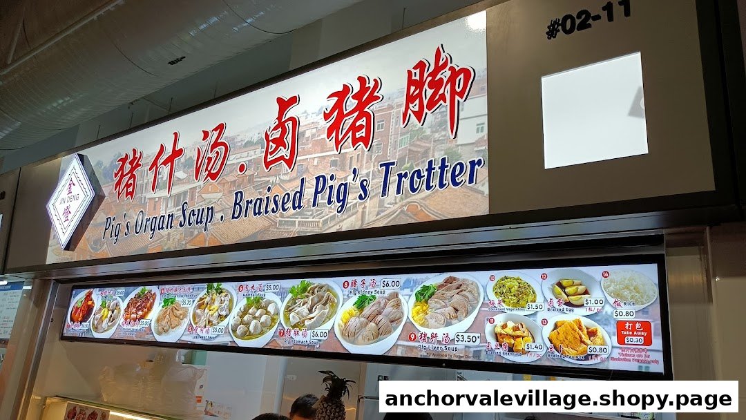 A brightly lit signboard displaying the shop name and a comprehensive menu with food images and prices.