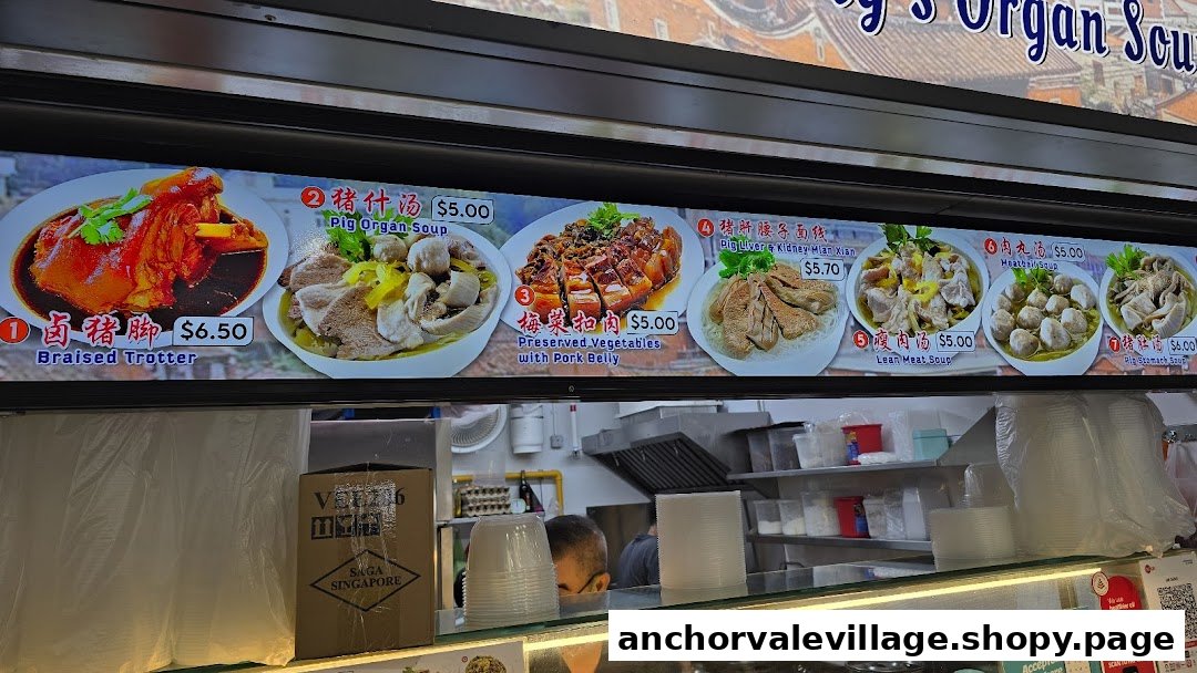 A digital menu board displaying various pork dishes and soups with prices at a food stall.
