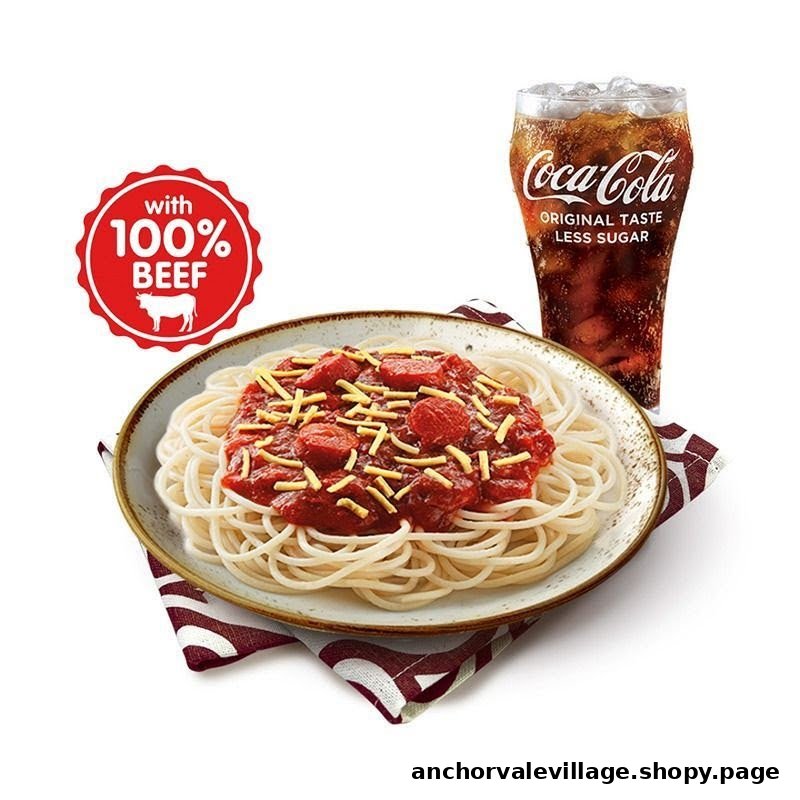 A plate of Jollibee's signature spaghetti with a Coca-Cola drink, featuring 100% beef.
