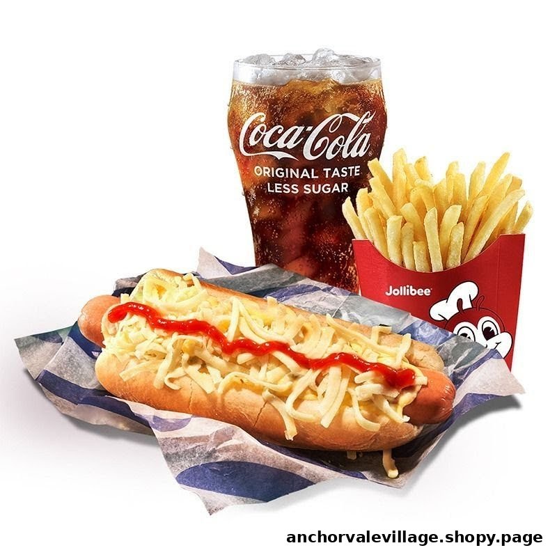 A Jollibee hotdog with cheese and ketchup, served with crispy fries and a refreshing Coca-Cola.