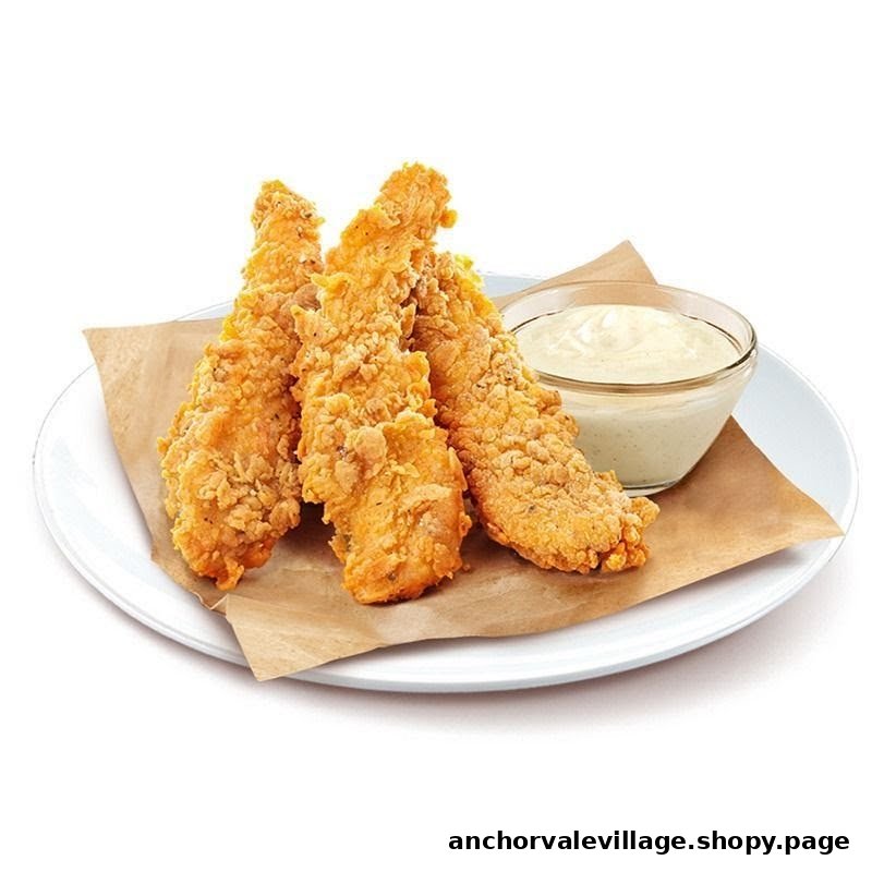 Crispy golden chicken tenders served with a creamy dipping sauce on a white plate.