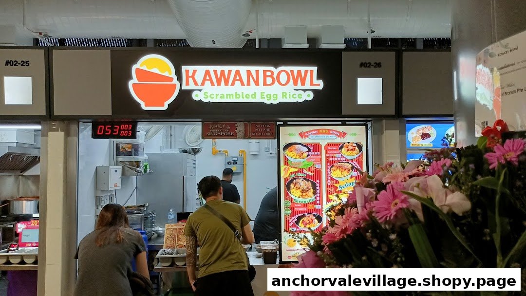 A bustling counter at Kawan Bowl, featuring its bright signage and menu displays, with customers ordering.