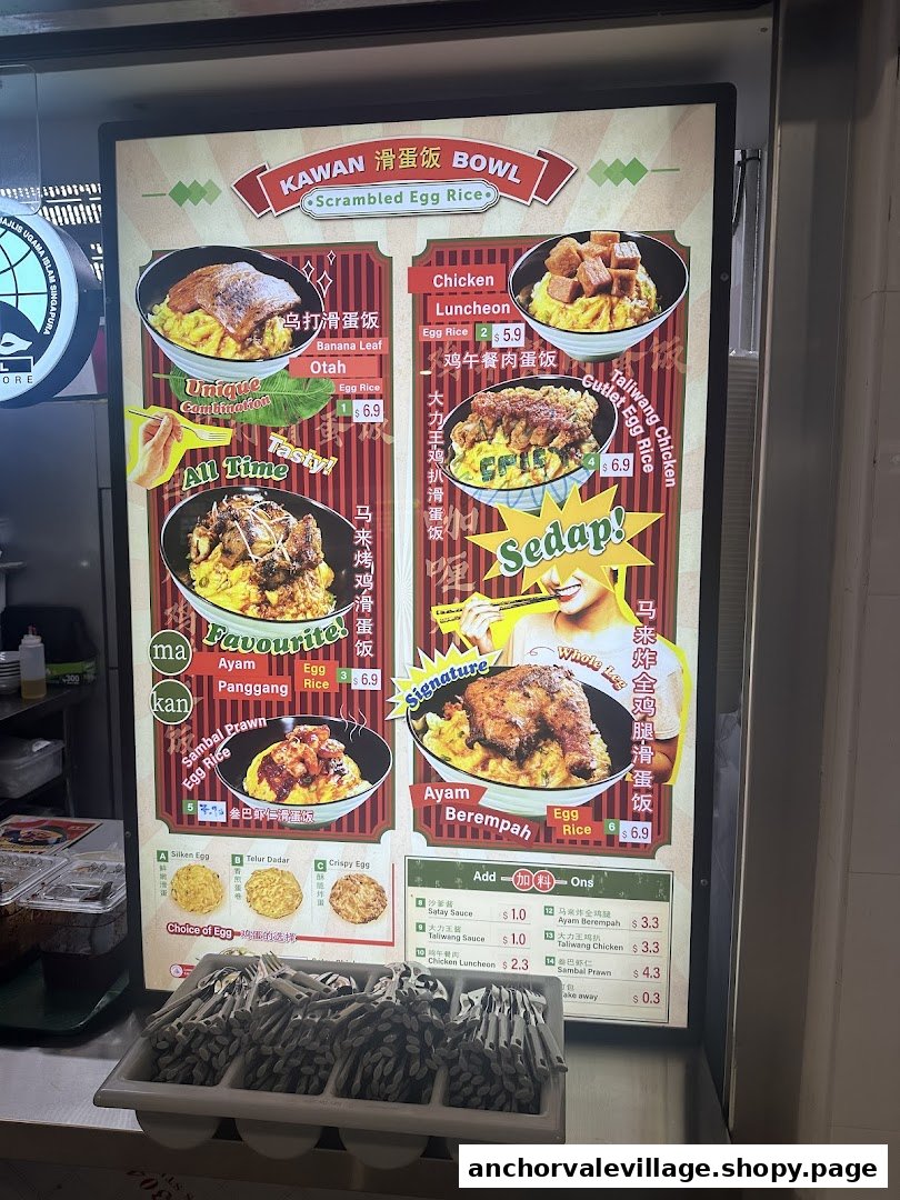A brightly lit menu board for Kawan Bowl, showcasing various scrambled egg rice dishes with different toppings.
