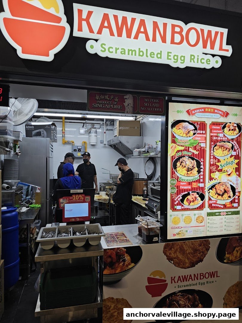 The shop front of Kawan Bowl, specializing in scrambled egg rice, with staff preparing food and a vibrant menu display.