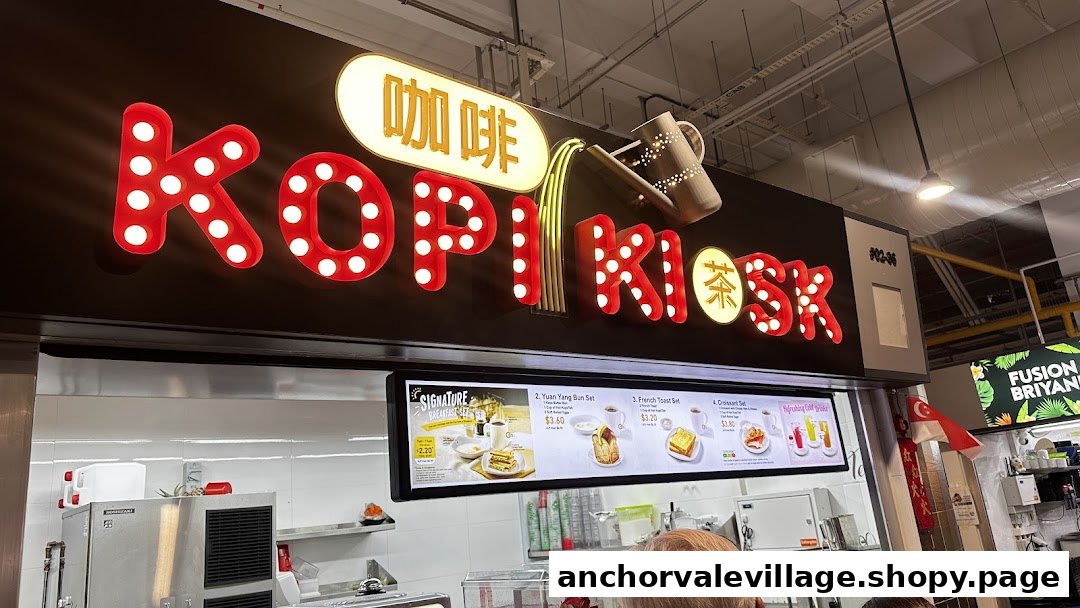 The vibrant Kopi Kiosk sign with red illuminated letters and a digital menu board below.