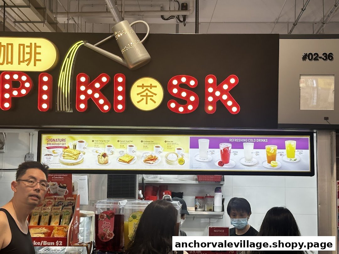 A clear view of Kopi Kiosk's menu board displaying breakfast sets and refreshing cold drinks.