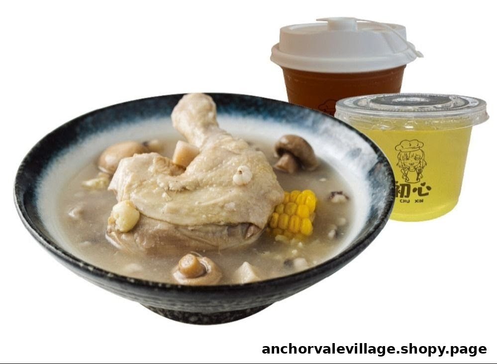 A hearty bowl of chicken soup with mushrooms and corn, accompanied by two refreshing beverages.