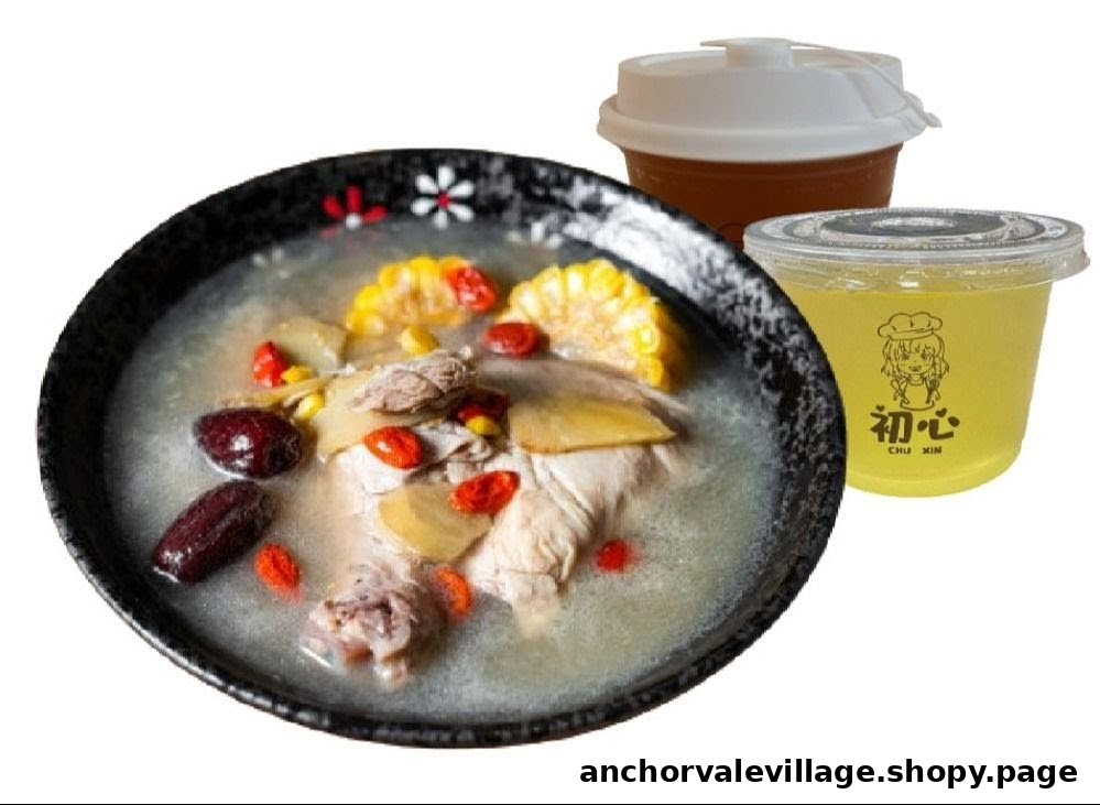 A hearty bowl of chicken soup with corn, red dates, and goji berries, served with two refreshing drinks.