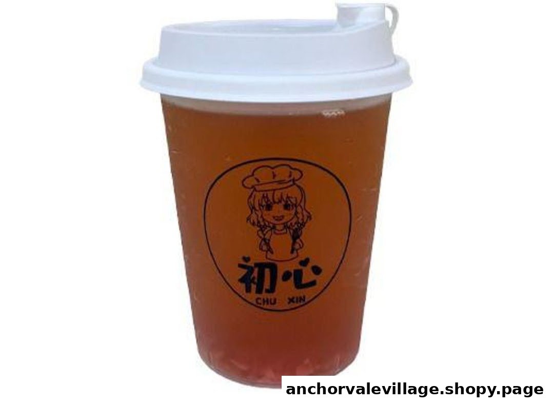 A clear plastic cup filled with a reddish-brown beverage, featuring a cartoon chef logo.