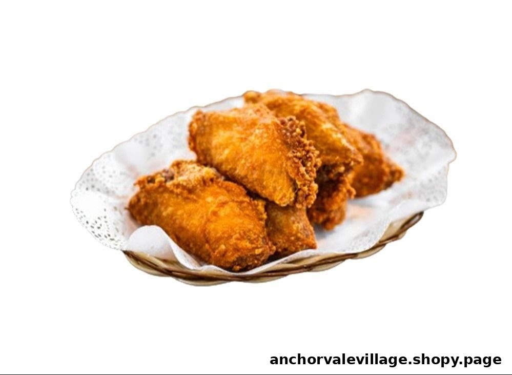 A basket of golden-brown crispy fried chicken wings on a white doily.