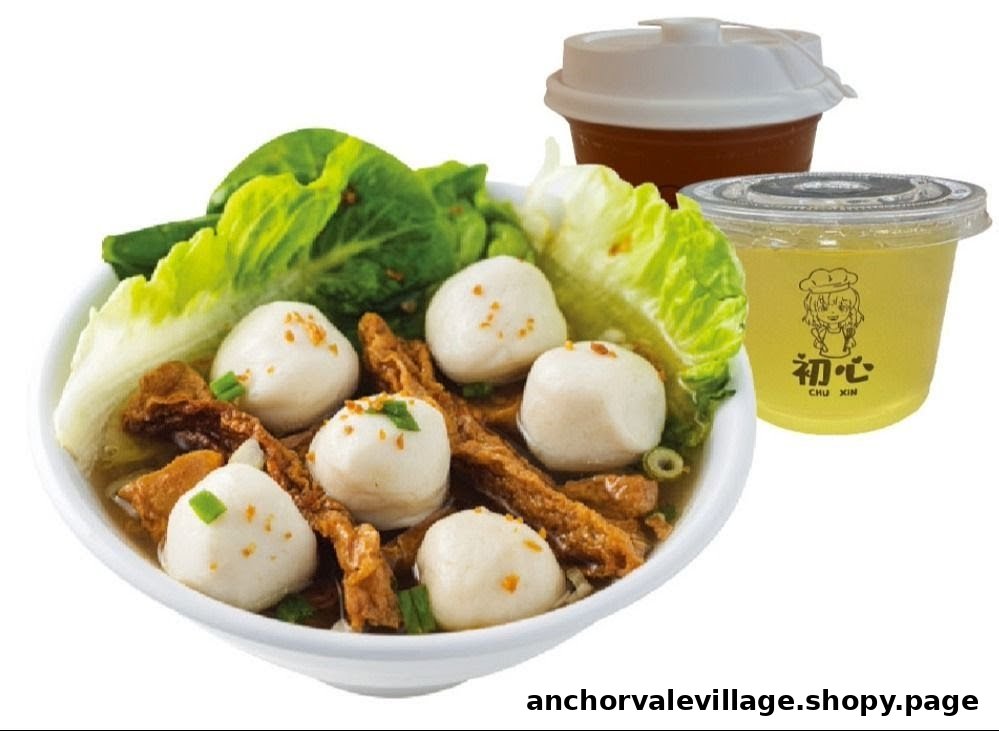 A bowl of fishball soup with lettuce and fried beancurd, accompanied by two beverages.
