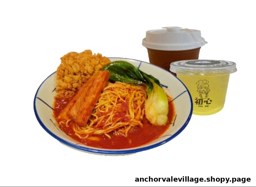 A plate of noodles with fried chicken, a cutlet, bok choy, and two beverages.