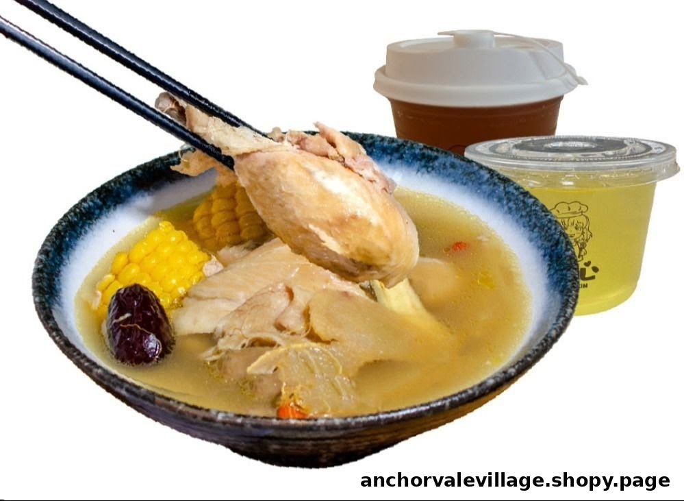 A hearty bowl of chicken soup with corn, dates, and other ingredients, served with two beverages.