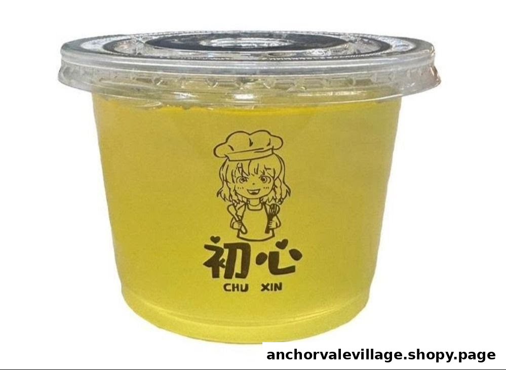 A yellow cup with a clear lid, featuring a cartoon chef logo and '初心 CHU XIN' text.