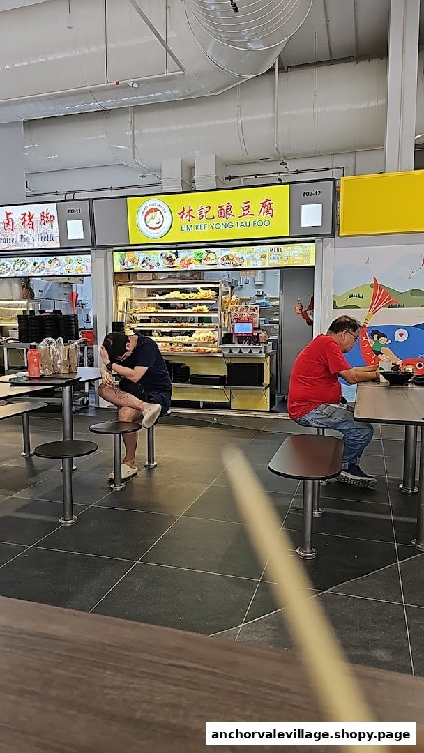 A bustling food court scene featuring the Lim Kee Yong Tau Foo stall with customers dining.