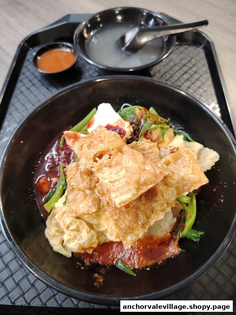 A delicious bowl of Yong Tau Foo with crispy beancurd skin, vegetables, and a rich sauce.