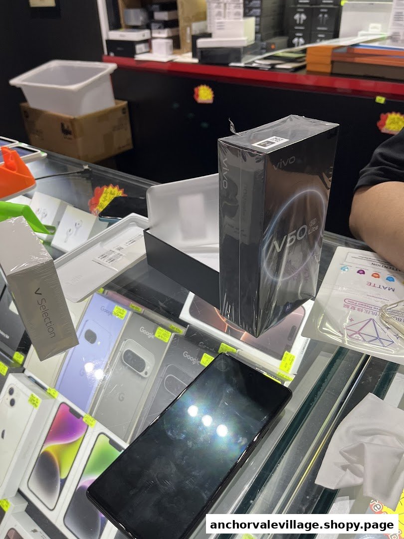 A mobile phone shop display counter with smartphones, accessories, and a new Vivo phone box.