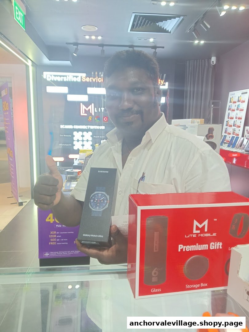 A man gives a thumbs-up while holding a Samsung Galaxy Watch Ultra box inside Lite Mobile.