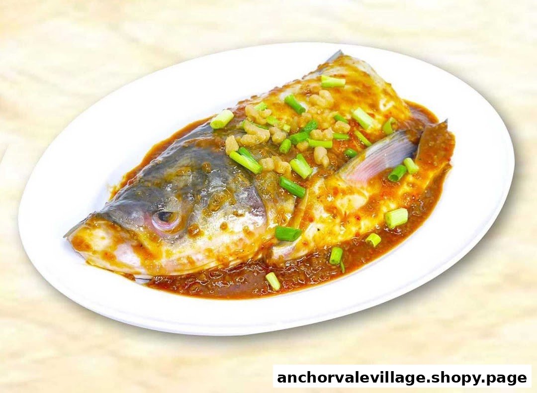A beautifully presented whole fish dish, steamed or braised in a rich sauce, garnished with green onions.