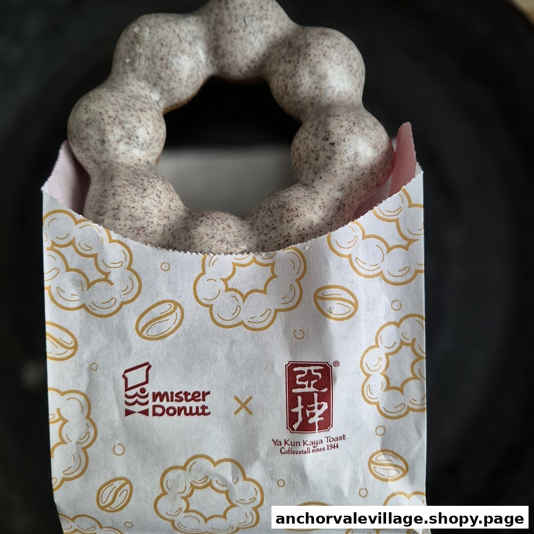 A unique Mister Donut x Ya Kun Kaya Toast collaboration donut in a branded paper bag.