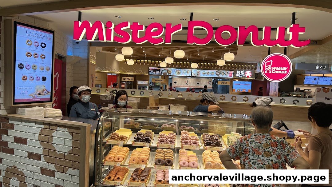 Customers select from a colorful display of fresh donuts at Mister Donut's vibrant counter.
