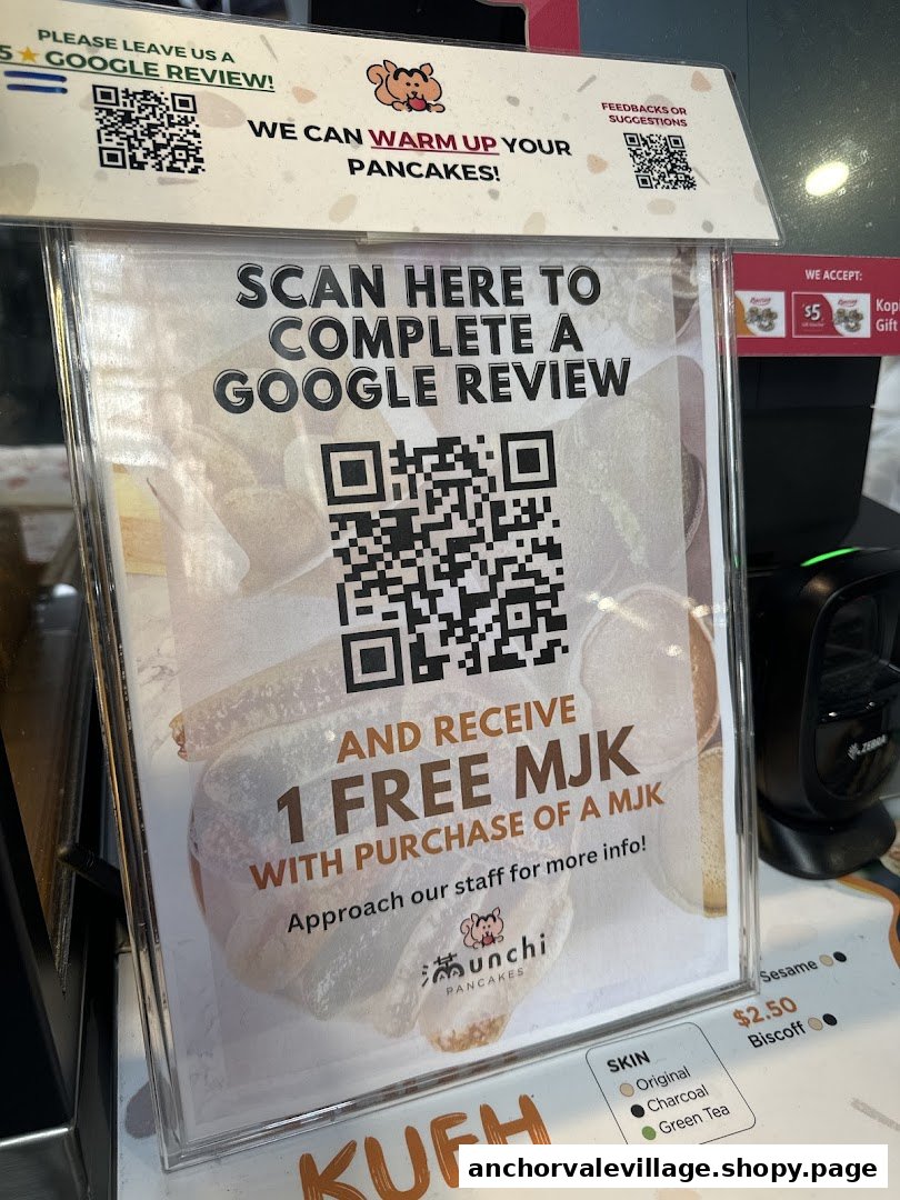 A sign at Munchi Pancakes promoting Google reviews for a free item, with partial menu details visible.