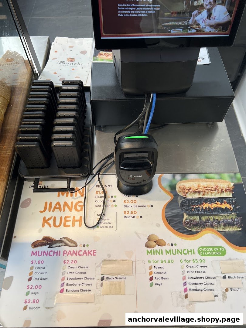A detailed view of the Munchi Pancakes counter, showcasing their menu board with various pancake options and prices.