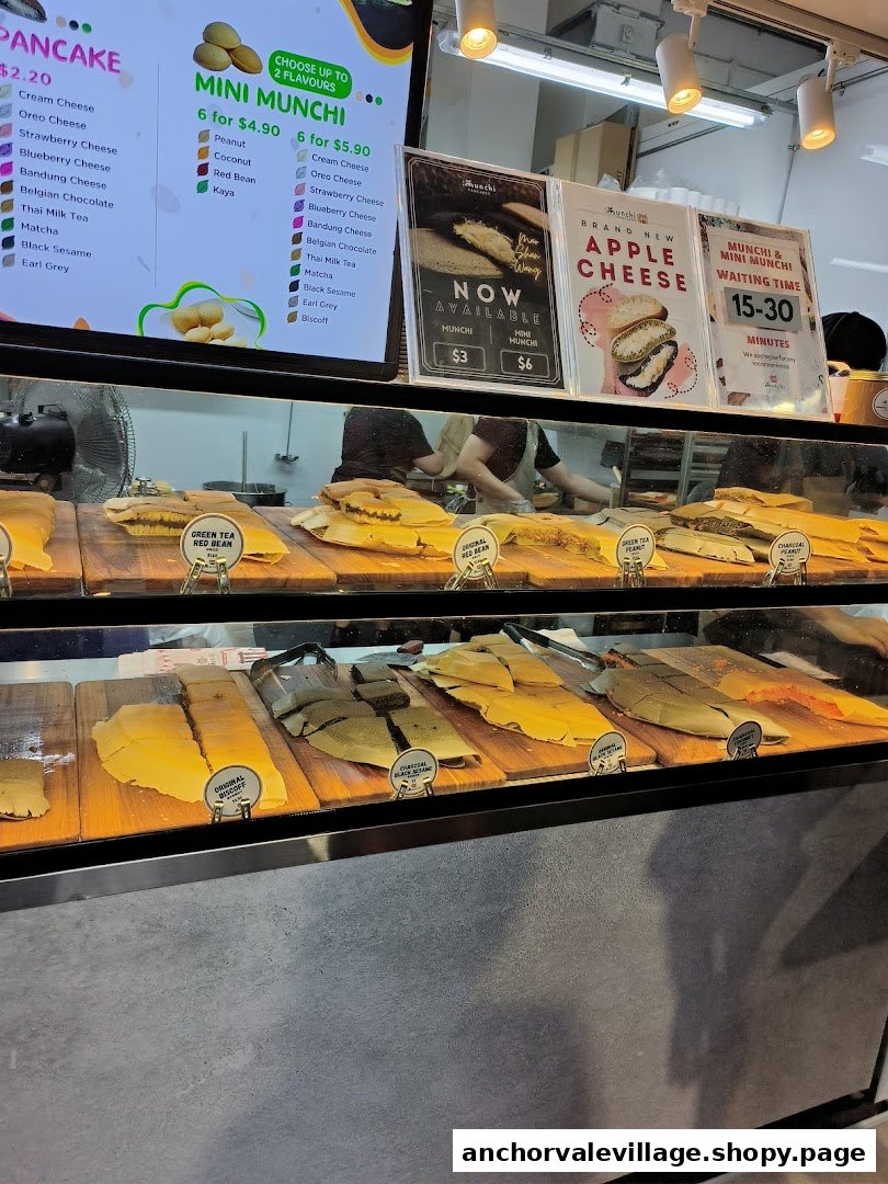 A vibrant display counter showcasing various pancake flavors and a detailed digital menu board.