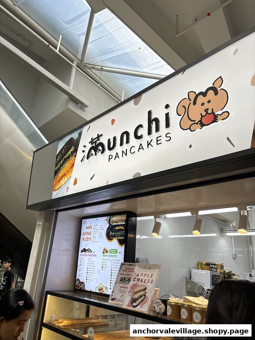A vibrant counter view of Munchi Pancakes, featuring its distinctive branding and fresh pancake display.