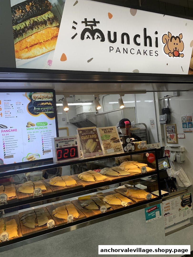 A bustling counter at Munchi Pancakes, showcasing freshly prepared pancakes and menu displays.