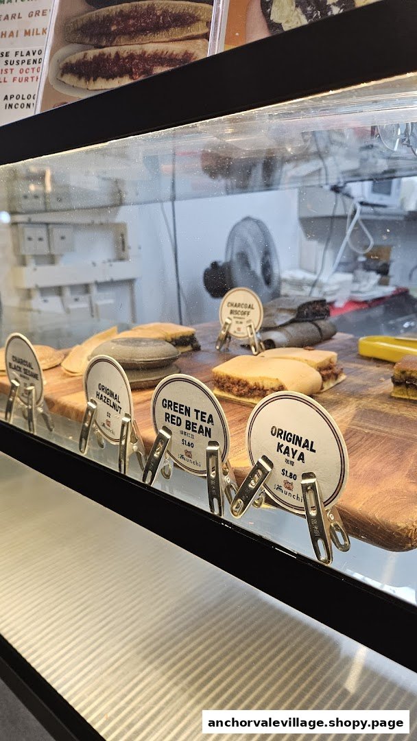 A display case showcasing various Munchi Pancakes with different fillings and price tags.
