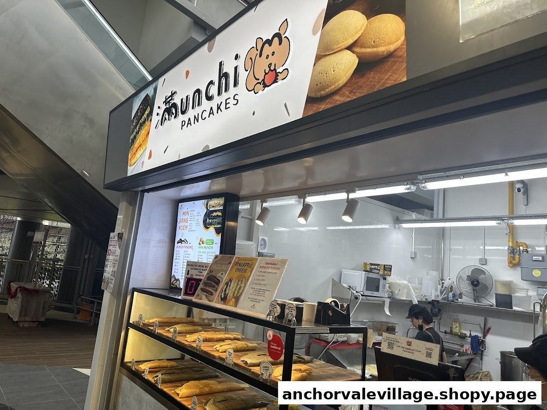 Munchi Pancakes shop counter displaying various pancakes and a staff member preparing orders.