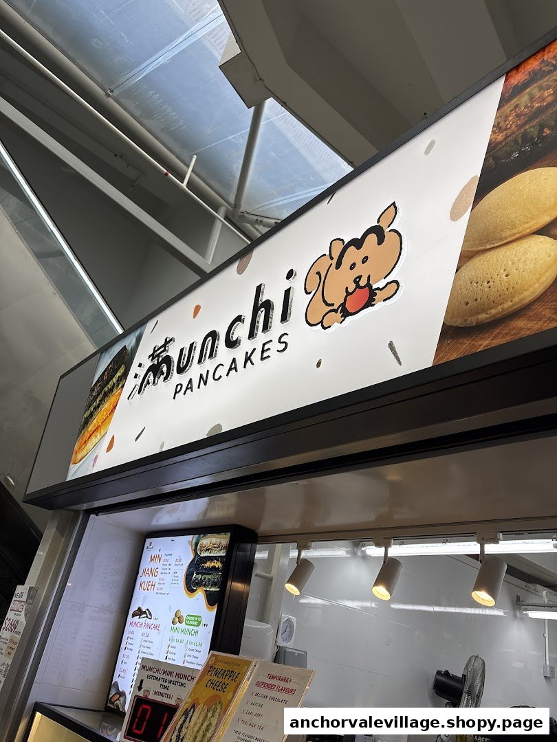 A vibrant view of the Munchi Pancakes stall, showcasing its menu board and branding.