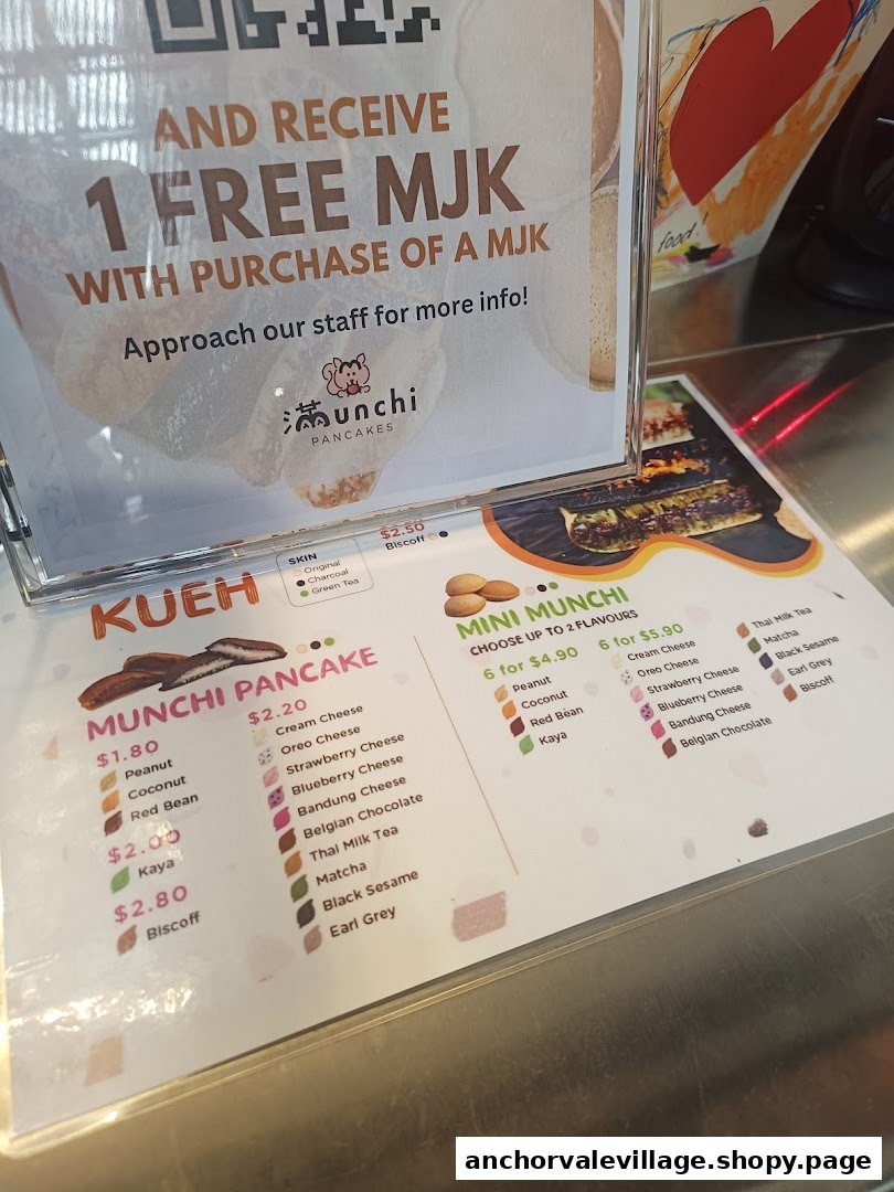 A detailed menu board for Munchi Pancakes, showcasing various pancake flavors, prices, and a special offer.