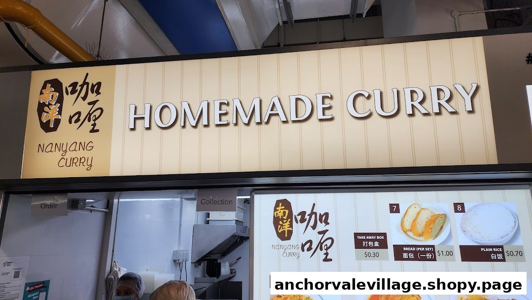 A close-up of Nanyang Curry's stall sign and partial menu board featuring homemade curry options.