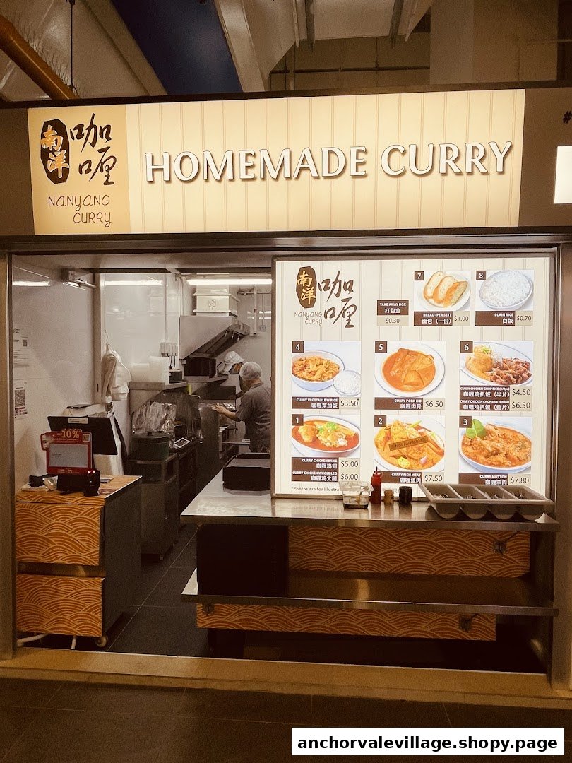 A brightly lit shop front of Nanyang Curry, featuring a prominent menu display with various curry dishes.