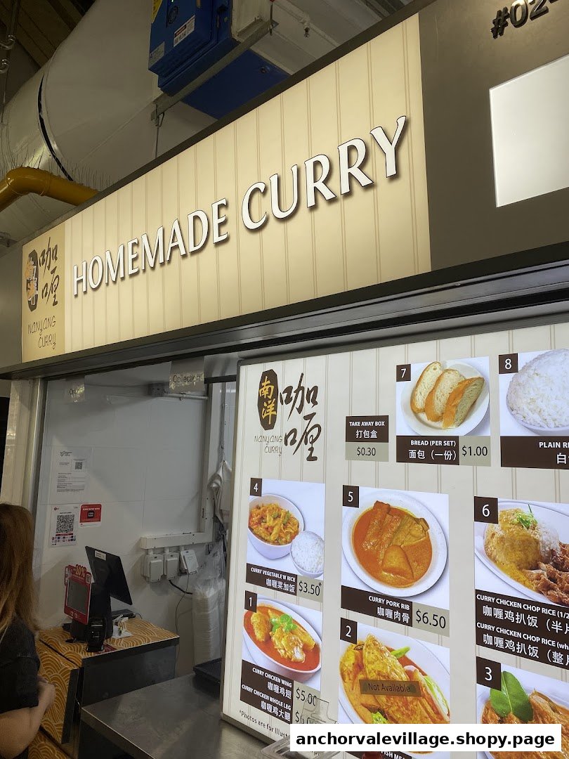 A brightly lit menu board for Nanyang Curry, showcasing various curry dishes and prices.