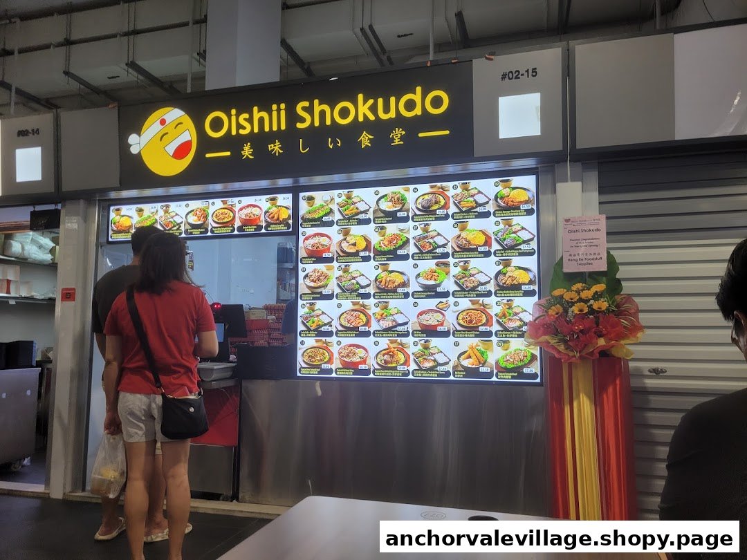 Customers queueing at the brightly lit Oishii Shokudo Japanese food stall with a large menu display.