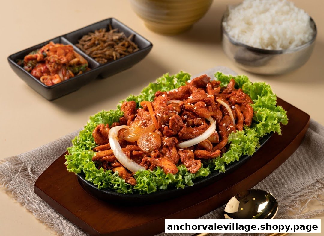 A vibrant dish of spicy stir-fried meat with lettuce, served with rice and side dishes.