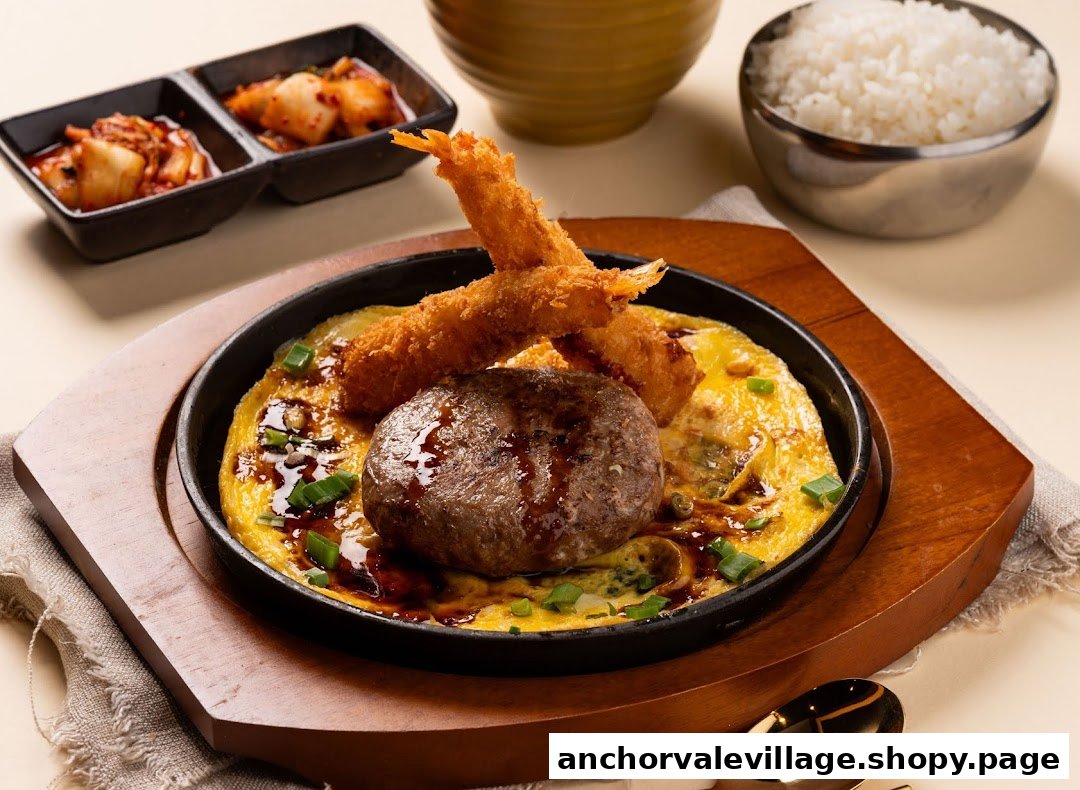 A sizzling plate featuring a hamburger patty, fried shrimp, and omelet, served with rice and kimchi.