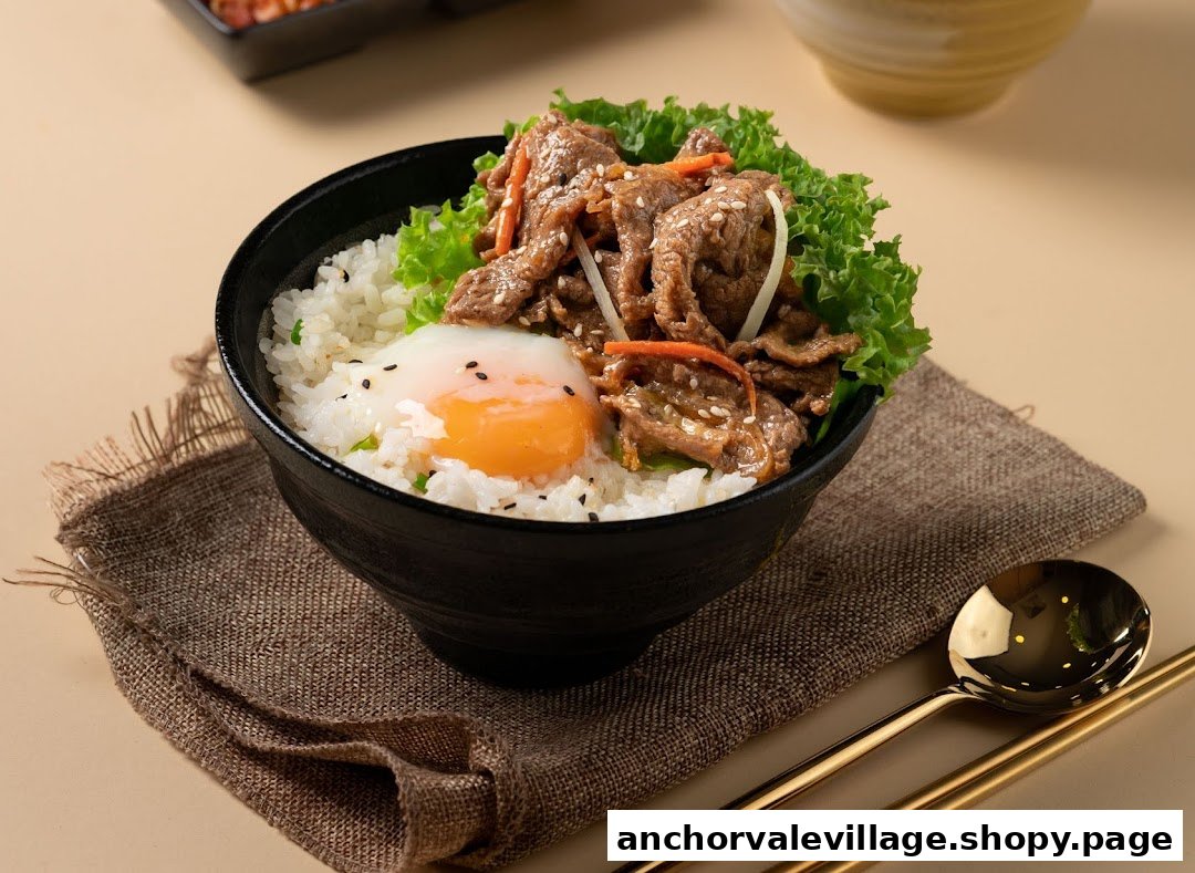A delicious bowl of rice topped with savory beef, fresh lettuce, and a perfectly poached egg.