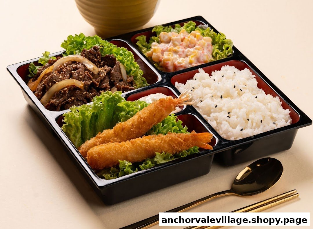 A delicious bento box featuring beef, tempura prawns, rice, and a side salad.